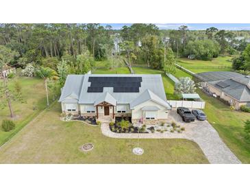 Stunning single-story home with well-manicured lawn, solar panels, and inviting entrance at 6745 Old Melbourne Hwy, St Cloud, FL 34771