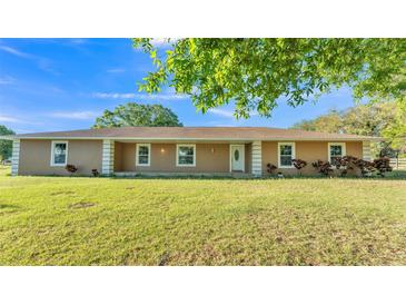Charming single-story home with a well-manicured lawn, front porch, and a welcoming front door at 6981 Snell Rd, Bartow, FL 33830