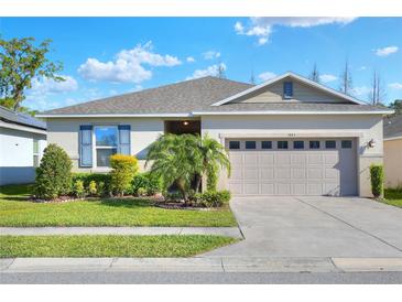 Charming single-story home with a well-manicured lawn and a two-car garage at 7445 Ibis Dr, Lakeland, FL 33810