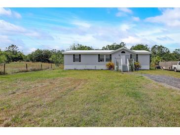 Charming single-story home featuring a front porch and spacious yard at 900 Saddlewood Blvd, Lakeland, FL 33809