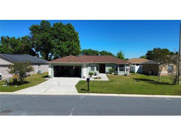 Well-maintained single-story home featuring a lush green lawn, driveway, and an attached garage at 8181 Bristol Bay Ave, Lakeland, FL 33810