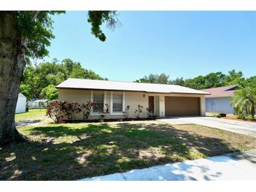 Charming single-story home with well-maintained landscaping and a metal roof at 1618 Crystalview Trl, Lakeland, FL 33801