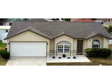 Charming single-story home featuring a two-car garage and well-maintained landscaping at 7968 Charleston Blvd, Lakeland, FL 33810