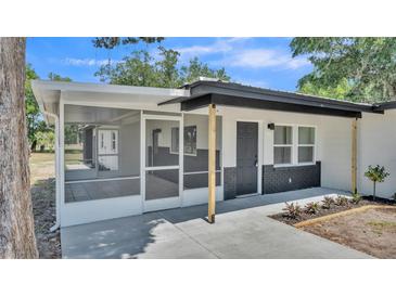 Charming single-story home featuring a screened porch and freshly painted exterior accents at 1650 W Mcleod St, Bartow, FL 33830