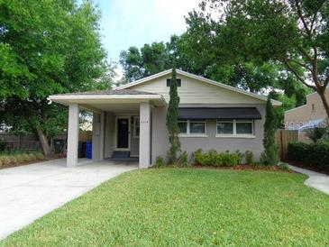 Gray exterior home with large front yard, covered parking, and manicured landscaping at 1014 Lexington St, Lakeland, FL 33801