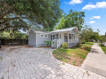 Charming gray home featuring a spacious front yard and inviting covered porch at 219 Ariana St # A-B, Lakeland, FL 33803