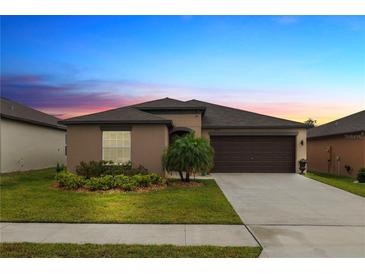 Charming single-story home with a well-manicured lawn, complemented by a two car garage and beautiful landscaping at 2726 Red Egret Dr, Bartow, FL 33830