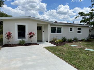 Charming single-story home featuring a well-manicured front yard and a freshly painted exterior and concrete driveway at 3227 Decatur Ave, Lakeland, FL 33805