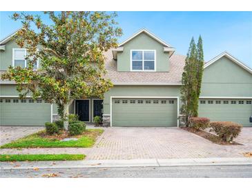 Inviting townhome with a two-car garage, manicured landscaping, and charming curb appeal at 6506 Sedgeford Dr, Lakeland, FL 33811