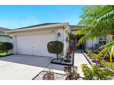 Inviting home exterior with a well-manicured lawn and a two-car garage at 7139 Cedarcrest Blvd, Lakeland, FL 33810