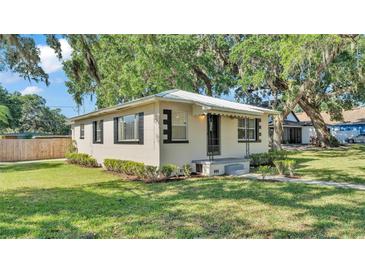 Charming single-story home featuring a well-manicured lawn and mature trees providing ample shade at 747 E Bella Vista St, Lakeland, FL 33805
