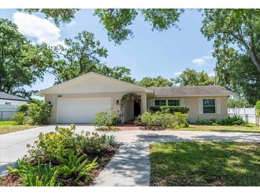 Charming single-story home with well-manicured lawn, arched entryway and white garage door at 1503 Clairdale Ln, Lakeland, FL 33801