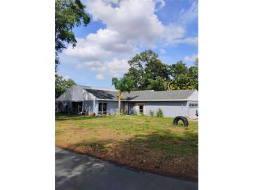 Spacious single-story home with a manicured lawn and mature trees at 4734 Valley Hill Ct, Lakeland, FL 33813