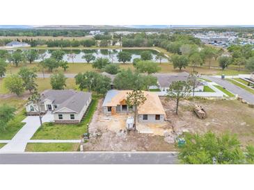 New construction home with a pond view, situated in a community with lush landscaping at 505 Shanklin Ave, Bartow, FL 33830