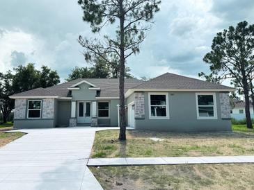 New construction home featuring stone accents, neutral colors and an attached two car garage at 505 Shanklin Ave, Bartow, FL 33830