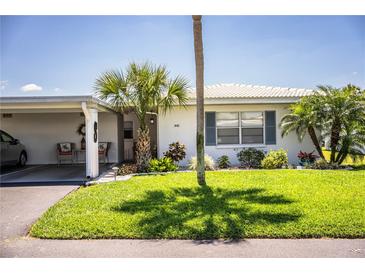 Charming home featuring a well-maintained lawn, landscaping, and a convenient carport at 610 Cottage Ln, Lakeland, FL 33803