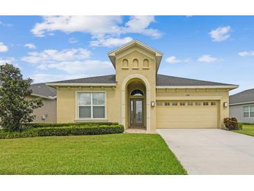 Charming single-story home featuring a well-manicured lawn and a two-car garage at 1049 Stoney Creek Dr, Lakeland, FL 33811