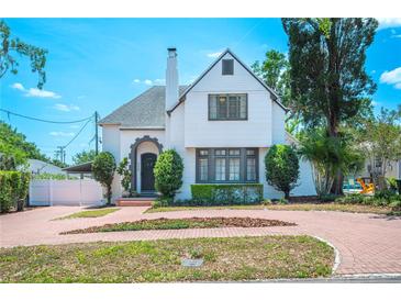 Charming two-story home with a red brick circular driveway and landscaped front yard at 112 Hiawatha Trl, Lakeland, FL 33803