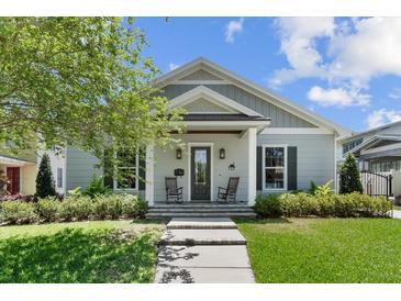 Charming single-story home with inviting front porch and landscaped garden at 117 Palmola St, Lakeland, FL 33803