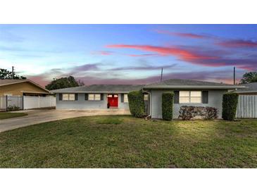 Charming single-story home featuring a red front door and well-manicured landscaping at 170 Browning Cir, Winter Haven, FL 33884