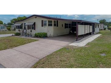 Charming single-story home with a carport and well-maintained landscaping at 1823 Sherwood Hill Dr, Lakeland, FL 33810