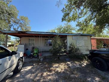 Exterior shot of a single-story home with a covered porch, showing condition of siding, and lawn at 216 Varnadoe Rd, Winter Haven, FL 33880