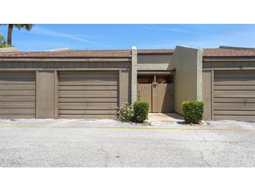 Townhouse front entrance featuring a private door and single-car garage at 2500 21St Nw St # 78, Winter Haven, FL 33881