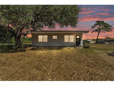 Charming single-story home at dusk with a well-maintained lawn and mature landscaping at 3728 Old Polk City Rd, Lakeland, FL 33809