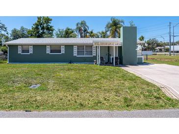 Charming home featuring a well-maintained front yard with mature trees at 4830 Melody Ln, Lakeland, FL 33805