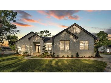 Beautiful single-story home featuring stone facade, manicured lawn, and a modern-style entrance at 5087 Cliffside Drive, Lakeland, FL 33813