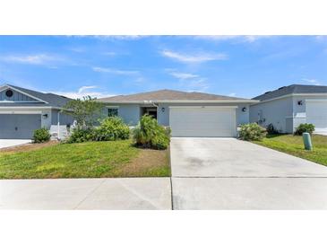 Charming single-story home with a well-manicured lawn, two-car garage, and welcoming entrance at 613 Sarner Pass Way, Winter Haven, FL 33881