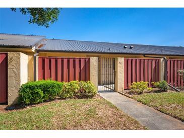 Charming townhome featuring a well-manicured lawn, privacy fence and secure gated entry at 697 Broadmoor Cir, Winter Haven, FL 33884