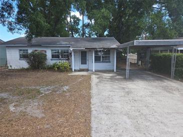 Modest single-story home with a carport and small front porch; showing signs of wear at 411 Keat Ave, Auburndale, FL 33823