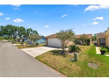 Charming home featuring a two-car garage and neatly landscaped front yard at 4428 Glenns Lndg, Winter Haven, FL 33884
