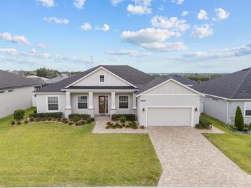 Charming single-story home with manicured lawn, stone accents, and a paved driveway at 6627 Ridgemont Rd, Lakeland, FL 33813