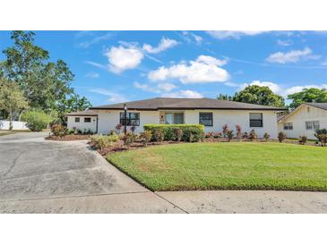 Charming single-story home featuring a well-maintained lawn, tasteful landscaping, and a concrete driveway at 1433 Ellison Ln, Lakeland, FL 33801