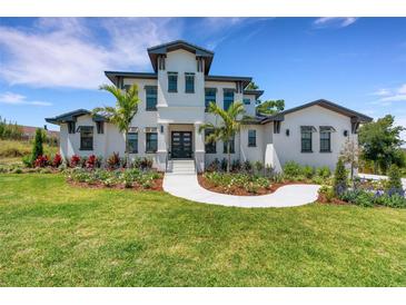 Beautiful two-story home with manicured lawn and garden at 2645 Delphi Hills Ct, Lakeland, FL 33812