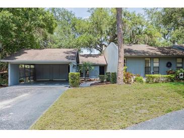 Charming home featuring a well-manicured front yard and attached garage at 319 Shadow Moss Ct # 319, Lakeland, FL 33813