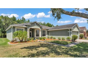 Charming home featuring lush landscaping, a well-manicured lawn, and beautiful curb appeal at 3252 Bellflower Way, Lakeland, FL 33811