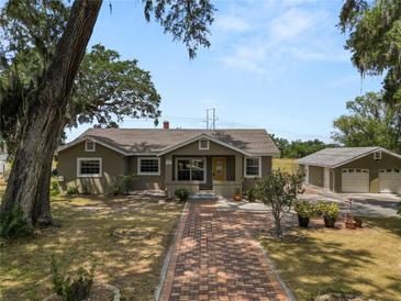 Charming single-story home featuring a brick walkway and well-maintained landscaping, plus a detached two car garage at 5201 Dorman Rd, Lakeland, FL 33813