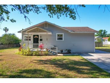 Charming single-story home with gray siding, a covered front porch, and well-maintained landscaping at 737 Kensington St, Lakeland, FL 33803