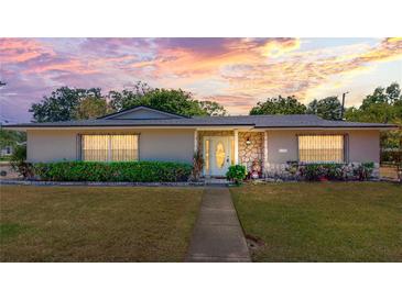 Charming home featuring stone accents, a well-manicured lawn, and a welcoming front entrance at 1195 E George St, Bartow, FL 33830