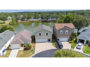 Aerial view of waterfront homes featuring well-maintained lawns and a tranquil lake setting at 2015 Hatteras Pt, Lakeland, FL 33813