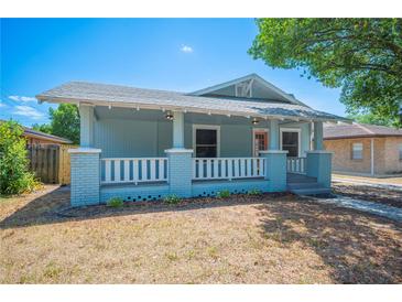 Charming single-story home boasts a welcoming front porch and well-maintained landscaping at 202 W Hancock St, Lakeland, FL 33803