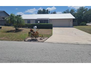 Charming single-story home with well-manicured landscaping and a driveway at 2213 Eastmeadows Rd, Lakeland, FL 33812