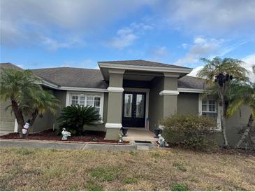 Charming single-story home featuring mature landscaping, a covered entrance, and decorative accents at 2663 Brookside Bluff Loop, Lakeland, FL 33813