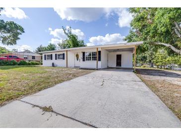 Charming single-story home with a spacious driveway, covered carport, and a well-maintained front yard at 280 W Pierce St, Lake Alfred, FL 33850