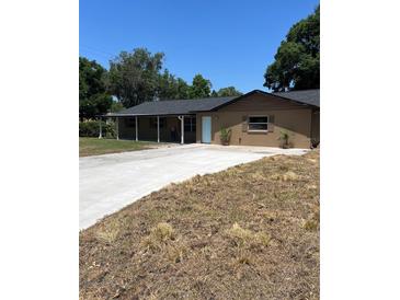 Charming single-story home featuring a covered front porch and long driveway at 4127 Grove Pl, Lakeland, FL 33810