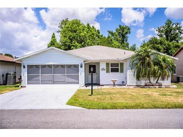 Charming single-story home with a well-manicured lawn and a screened two-car garage, offering curb appeal at 4976 Pleasant Hollow Trl, Lakeland, FL 33811