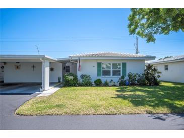 Charming single-story home with well-maintained lawn and vibrant landscaping enhancing curb appeal at 512 Cameo Dr, Lakeland, FL 33803